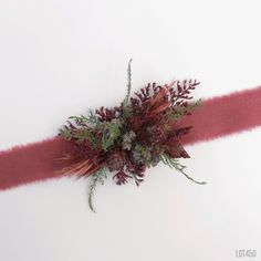 a bunch of flowers sitting on top of a red ribbon