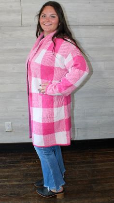 A pink long cardigan with a checkered design on it. This will keep you warm in the up-coming fall/ winter season. Fit: true to size Small: 2-4 Medium: 6-8 Large: 10-12 Model: medium Laundry: wash on cold, hang to dry Cozy Plaid Sweater For Spring, Pink Sweater For Fall Cold Weather, Pink Sweater For Cold Weather In Fall, Pink Spring Sweater For Cold Weather, Pink Sweater For Cold Spring Weather, Fall Gingham Outerwear With Long Sleeves, Pink Sweater For Spring Cold Weather, Pink Casual Cardigan For Cold Weather, Casual Pink Cardigan For Cold Weather