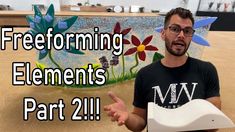 a man holding a paper plate with flowers on it and the words freeforming elements part 2