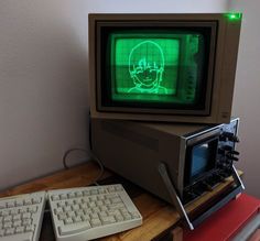 an old computer sitting on top of a wooden desk