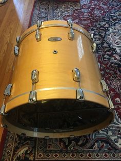 a yellow drum sits on top of a rug