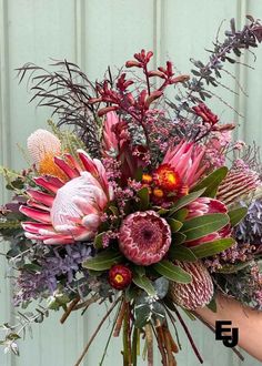 a person holding a bouquet of flowers in their hand