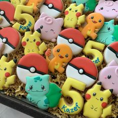 decorated cookies in the shape of pokemons and pikachu's on display