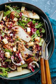 a salad in a bowl with apples and pecans