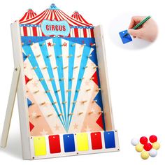 an image of a carnival game being played by someone's hand with colored pencils