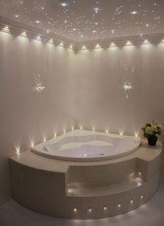 a large white bath tub sitting in the middle of a room with stars on the ceiling