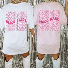 a woman wearing a pink disco shirt and white boots