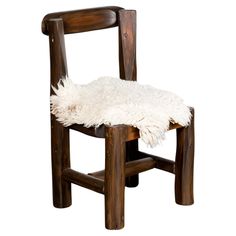 a wooden chair with a white sheepskin seat pad