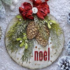 a christmas ornament with pine cones and red bows