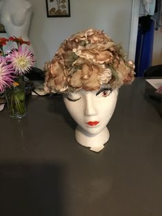 "Adorable little hat!   The base of the hat is a stiff netted fabric in cocoa brown, it is covered with chiffon flowers and  greenery.      Measures 7 1/2\" front to back of hat and 8\" side to side, measuring from under hat.  Hat is about 5\" tall.   21 1/2\" circumference inside around brim.     The label reads From the Young Towners Hat Shop.   Perfect for a garden party! thanks for stopping by my Etsy store!" Floral Garden Party, Rose Pink Dress, Hip Hop Bling, Floral Hat, Millinery Hats, Chiffon Flowers, Cocoa Brown, Beaded Collar, Vintage Hat