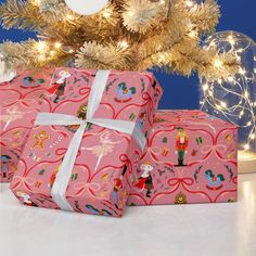 two wrapped presents sitting under a christmas tree