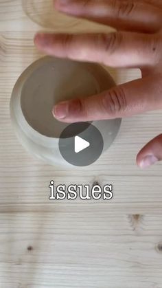 a person is touching the top of a bowl on a wooden table with text that reads issues