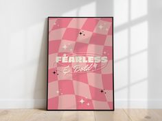 a pink poster with the words fearless and stars on it in front of a white wall