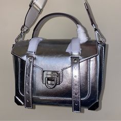 Michael Kors Purse Manhattan Medium Metallic Satchel New With Original Packaging And Stuffing 100 % Authentic Silver Color Metallic 55% Polyurethane 35% Polyester 10% Lurex Silver-Tone Hardware Approximate Measurements 10"W X 7.25"H X 4"D Long Strap 19”-21” Included Lining: 100% Polyester Flip-Lock Fastening New With Original Packaging Smoke And Pets Free Michael Kors Satchel With Silver-tone Hardware For Shopping, Michael Kors Satchel With Silver-tone Hardware, Michael Kors Silver Shoulder Bag With Branded Hardware, Michael Kors Silver Shoulder Bag For Evening, Michael Kors Silver Evening Shoulder Bag, Silver Michael Kors Shoulder Bag For Evening, Designer Metallic Crossbody Bag, Michael Kors Top Handle Shoulder Bag With Silver-tone Hardware, Michael Kors Shoulder Bag With Silver-tone Hardware