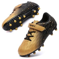 a pair of black and gold soccer shoes with spikes on the soles, side view