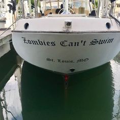 a white boat sitting in the water at a dock with another boat behind it that says, fortune can't swim