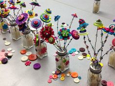 several vases filled with different types of buttons