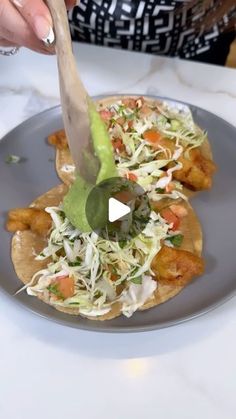 a person cutting up food on top of a plate