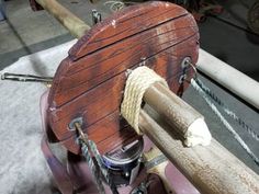 an old wooden boat is being worked on