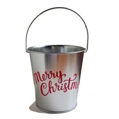 a metal bucket with merry christmas written on it's side and red lettering in the middle