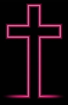 a neon cross on a black background with the word jesus christ written in white and pink