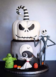 a three tiered cake decorated with halloween decorations