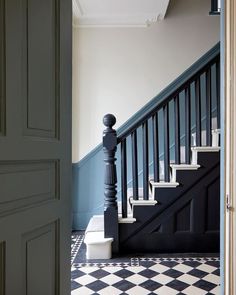 an open door leading to a black and white checkerboard floored entryway