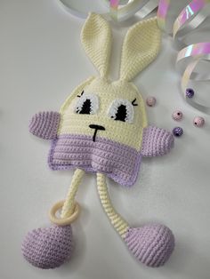 a crocheted bunny hat and pacifier on a table