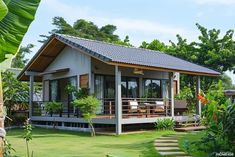 a small house sitting in the middle of a lush green yard with steps leading up to it