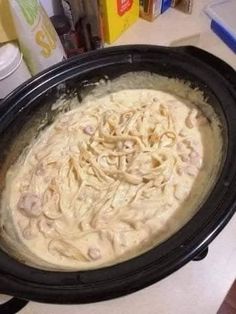 a black crock pot filled with food on top of a counter