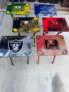 four tables with different logos on them are sitting in a parking lot next to each other