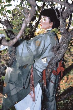 a mannequin is standing in the branches of a tree