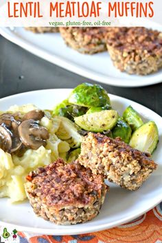 two white plates topped with meat patties and veggies next to a fork