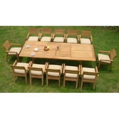 a large wooden table and chairs in the grass