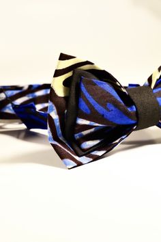 "A three-layered men's bowtie made with multicolored African fabric. This bowtie measures 5\" 3.5\". The strap, which is adjustable is made with standard 3-piece hook and eye slider bowtie hardware and is the same fabric as the bowtie. The strap goes up to 18\" If you have questions or want more information about this savvy bowtie or bulk ordering for any event, please feel free to make contact and we'll be happy to help! Dry clean only. Please note that there may be factors that could affect th Mens Bowtie, Kids Bow Ties, Bow Tie Wedding, Mens Bow Ties, African Fabric, African Print, Sliders, Blue, Fabric