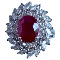 Indulge in luxury and sophistication with this 18k Diamond and Ruby Ring. Crafted with 18k white gold and marked with "K-18" and "T101", this exquisite ring weighs 8.4 grams. Adorned with a stunning 4.20 carat ruby center surrounded by 0.56 carats of diamond accents, this ring also features 1.35 carats of marquise diamonds for added elegance. Elevate any outfit with this timeless piece. Condition: In good condition with some minor surface wear consistent with age. Ring size: 6.75 Markings: "K-18” "T101" Metal: 18k White Gold Weight: 8.4 grams Marquise Diamonds: 1.35 carats Diamond Accents: 0.56 carats Ruby: 4.20 carats Diamond And Ruby Ring, Italian Romance, Glamour Wedding, Vintage Black Glamour, Glamorous Wedding, Old Hollywood Glamour, Marquise Diamond, Ruby Ring, Cluster Ring