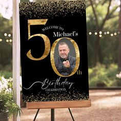 a black and gold 50th birthday celebration sign