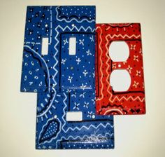 three different colored switchplate covers on a white surface with blue, red and orange designs