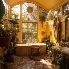 a bath room with a large tub next to a sink and a window filled with potted plants