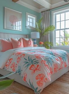 a bedroom with blue walls and white bedding has pink flowers on the comforter