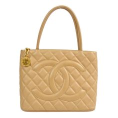 Chanel Medallion Quilted Hand Tote Bag Description OUTSIDE:  A: GOOD CONDITION!! There are scuffs and dirt on the bottom edges. INSIDE:  A+: VERY GOOD CONDITION!! S : New / new without a tag. SA : Excellent condition. A : Good condition with minor sigh of use. AB : Used condition with some damages. B : Obvious sigh of use with heavy damages. Details Number : 77***** Pocket : Outside: Pocket*1 Inside: Zipper Pocket*1, Pocket*1 Size(Inch) : W 11.8 x H 9.4 x D 5.9 "    Handle Drop. 5.9 "  Size(CM) : W 30.0 x H 24.0 x D 15.0 cm  Handle Drop. 15.0 cm Color : Beige Material : Caviar Skin Leather Comes with : Serial Sticker, Authenticity Card, Care Manual Made in : Italy SKU Number : 89084 (25) Shipping Free Shipping Worldwide. -【Expedited】 DHL or EMS or FedEx (can't choose carrier) Ship within 2 Chanel Medallion, Medallion Quilt, Leather Pocket, Quilted Totes, Tote Bag Purse, Tote Handbags, Calf Skin, Bags Handbags, Shoe Accessories