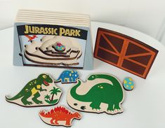 several wooden magnets in the shape of dinosaurs