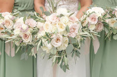 the bridesmaids are holding their bouquets with pink and white flowers on them