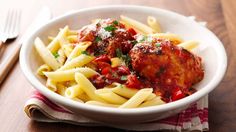 a white bowl filled with pasta and meatballs