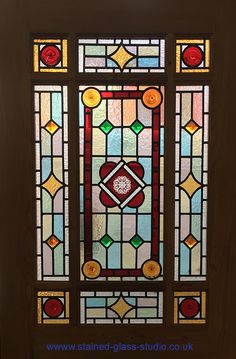 a stained glass window in the corner of a room