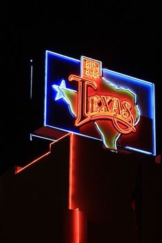 the texas sign is lit up at night