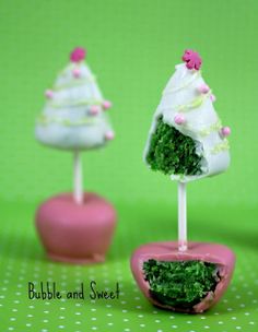 there are two cake pops on top of each other with white frosting and green toppings