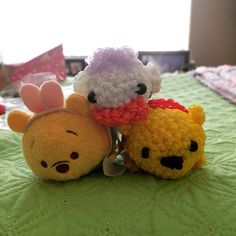 two stuffed animals sitting on top of a bed