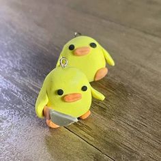 two yellow rubber ducks sitting on top of a wooden table