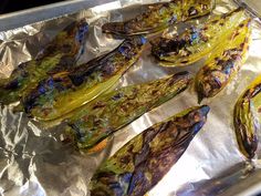 grilled vegetables sitting on top of aluminum foil in a baking pan, ready to be cooked